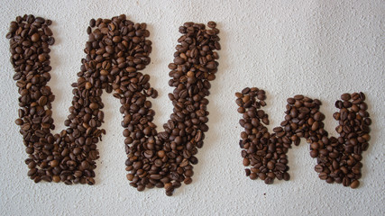 Image of roasted coffee beans shaped alphabet on a white background