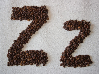 Image of roasted coffee beans shaped alphabet on a white background