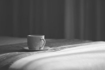 Fototapeta na wymiar Coffee cup on the bed