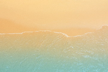 Texture background with surf, sea water and sand on the beach