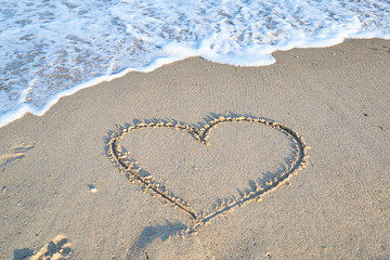 Love message on the beach sand - vacation and travel concep