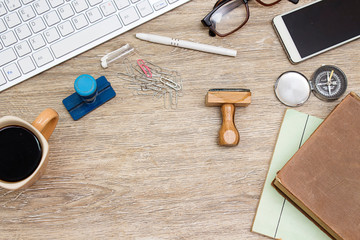 keyboard, glasses, stamp, pen coffee cup, compass, books and smart phone