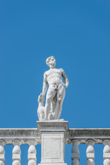 Fototapeta na wymiar Statue as roof decoration of Doge's Palace in Venice, Italy