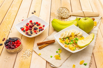 Healthy vegetarian (vegan) breakfast with oatmeal and fruits.