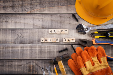 Labour Day, Wooden Block calendar with many handy tools on wooden background texture.