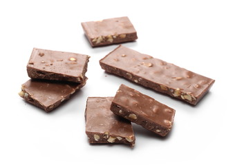 Chocolate with hazelnuts isolated on white background