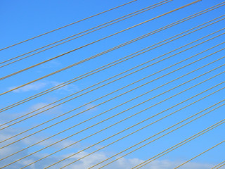 yellow wire rope sling of bridge with blue sky background