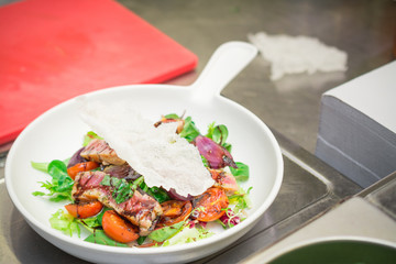 Healthy food on exclusive Italian cuts, fish, lettuce and tomatoes, balsamic vinegar