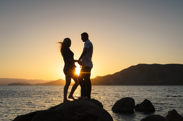 Silhouette couple against a sunset