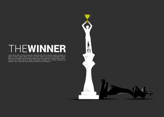 Silhouette of businessman standing on winner chess to checkmate. concept of winner in business and marketing strategy