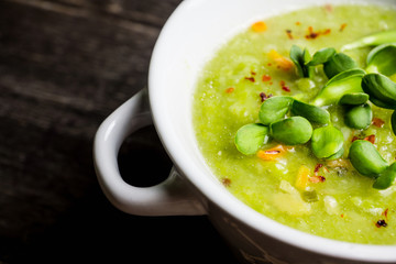 Hot green peas soup on the rustic background. Selective focus. Shallow depth of field.