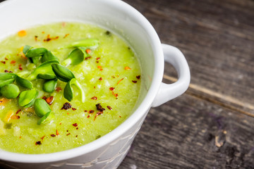 Hot green peas soup on the rustic background. Selective focus. Shallow depth of field.