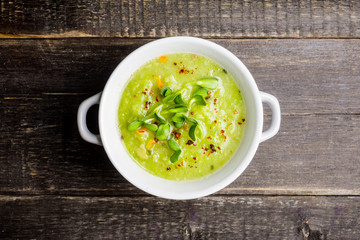 Hot green peas soup on the rustic background. Selective focus. Shallow depth of field.