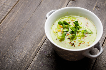 Hot green peas soup on the rustic background. Selective focus. Shallow depth of field.