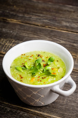 Hot green peas soup on the rustic background. Selective focus. Shallow depth of field.