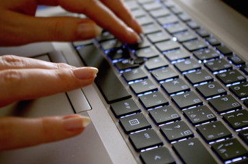 Woman hands typing on laptop, Close up of business woman's hands typing on laptop keyboard, internet banking concept