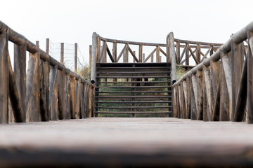 Naklejka premium Wooden footbridge in the dunes of the beach