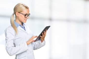 female doctor using her digital tablet