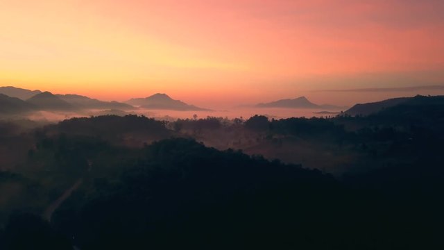 Landscape nature with aerial camera bird eye view. Aerial View, Flying over the mountains and forest with beautiful clouds and sky in sunrise.