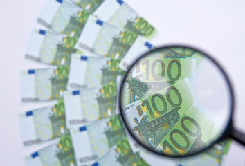 Euro with a  magnifying glass