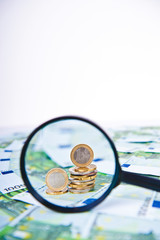 Euro with a  magnifying glass