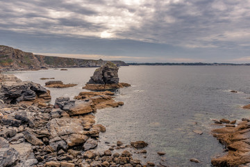 Fototapeta na wymiar French landscape - Bretagne. Rocky coast with wild cliffs in the background.