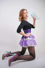 pretty cute slender fashion girl with plastic cup with water on white background