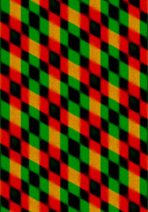 Abstract background, collected at an angle of intersection of red, green and black  rhombuses and covered with small black specks