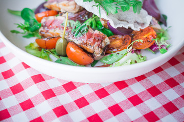 healthy food background or texture, fresh tasty vegetable salad with red fish, tomatoes, balsamic spicy