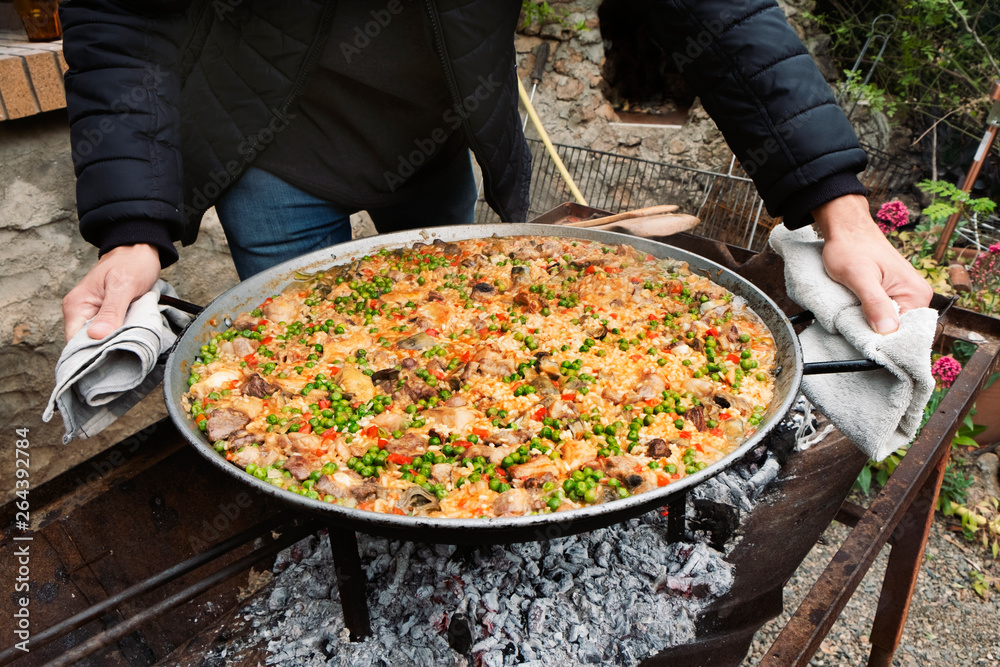 Poster man with a typical spanish paella