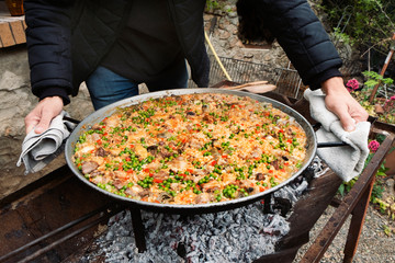man with a typical spanish paella