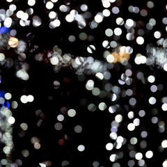 Abstract bokeh of white city lights on black background. defocused and blurred many round light