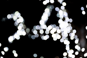 Abstract light bokeh as background defocused and blurred many round light on black background