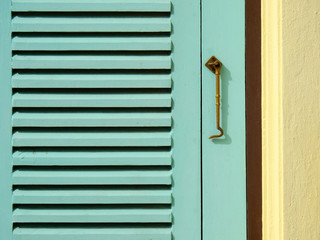 green wood window with hook on the wall