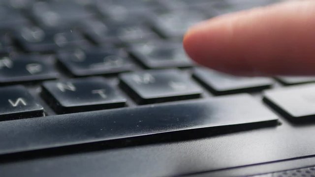 finger pushing the space bar button of keyboard