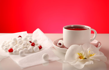 Cranberries in powdered sugar, with a cup of strong black tea.