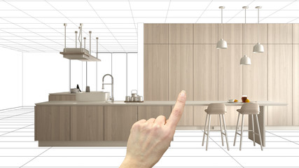 Unfinished project, under construction draft, concept interior design sketch, hand pointing real wooden kitchen with blueprint background, architect and designer idea