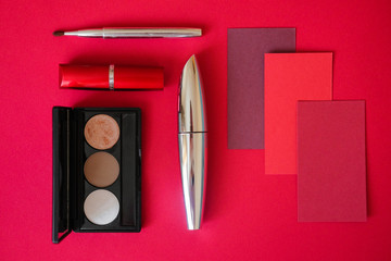 Make-up brushes on a bright pink background.
