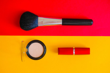 Make-up brushes on a bright pink background.