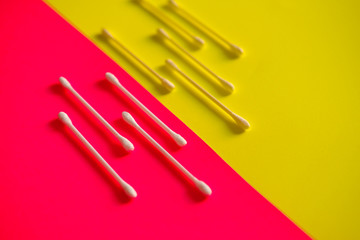 Cotton swab on a pink background.