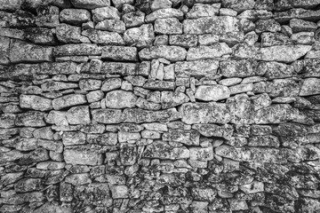 Artistic old wall background of black and white stone wall texture photo