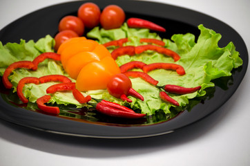 vegetables on a plate laid out in the shape of a scorpion	