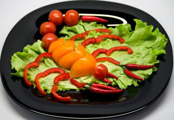 vegetables on a plate laid out in the shape of a scorpion	