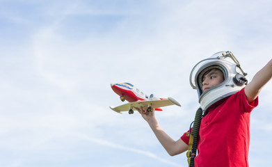 boy with astronaut helmet and plane.