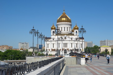 Fototapeta na wymiar Moscow, Russia - June 15, 2018: Cathedral of Christ the Saviour and Patriarchal bridge on a Sunny summer day