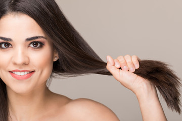 Closeup of a woman grabbing her beautiful hair in a studio