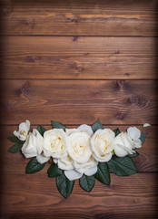 White roses decor on wooden background