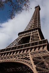 A low perspective of the Eiffel Tower with a blue sky on  an autumn day in Paris France