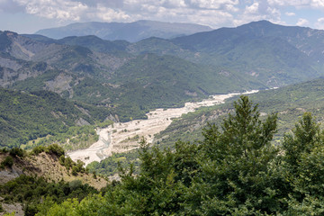 The mountains and the river Kalarrytikos (Greece)on a sunny summer day.