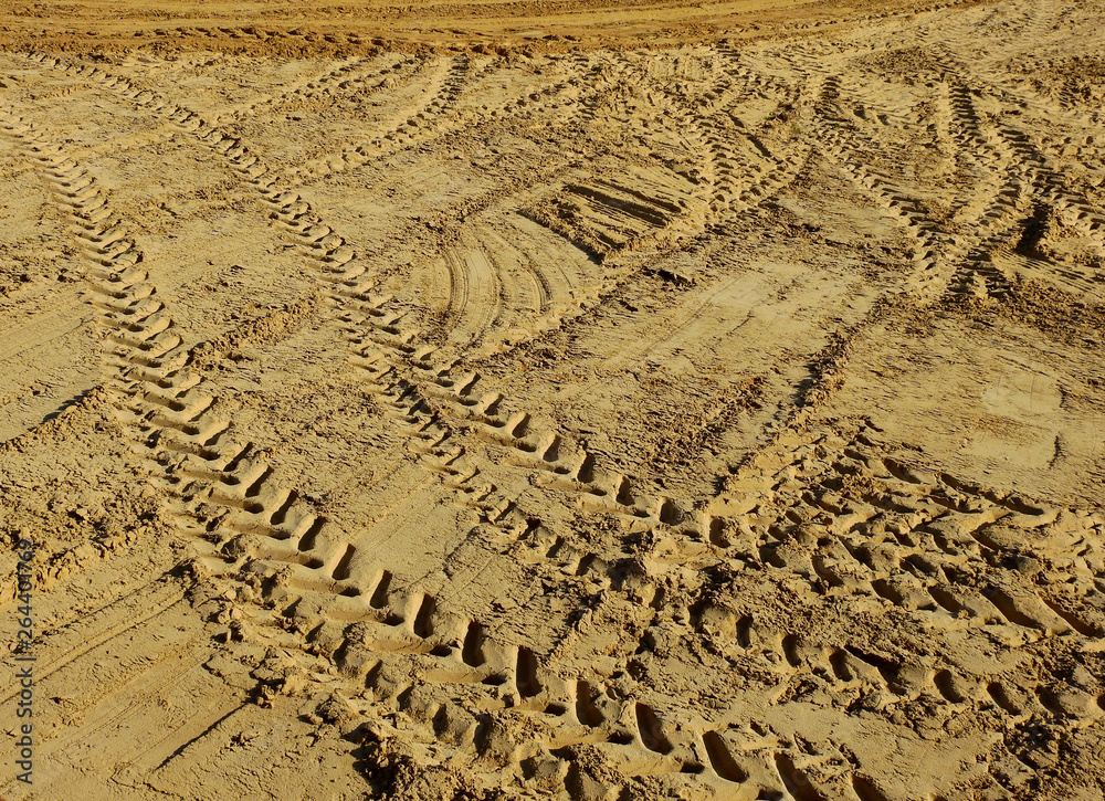 Wall mural Tractor wheel track mark on sand in construction site